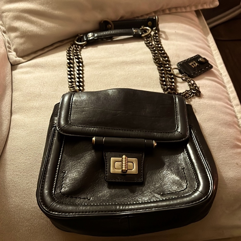 Olivia Harris black genuine leather handbag with chain.